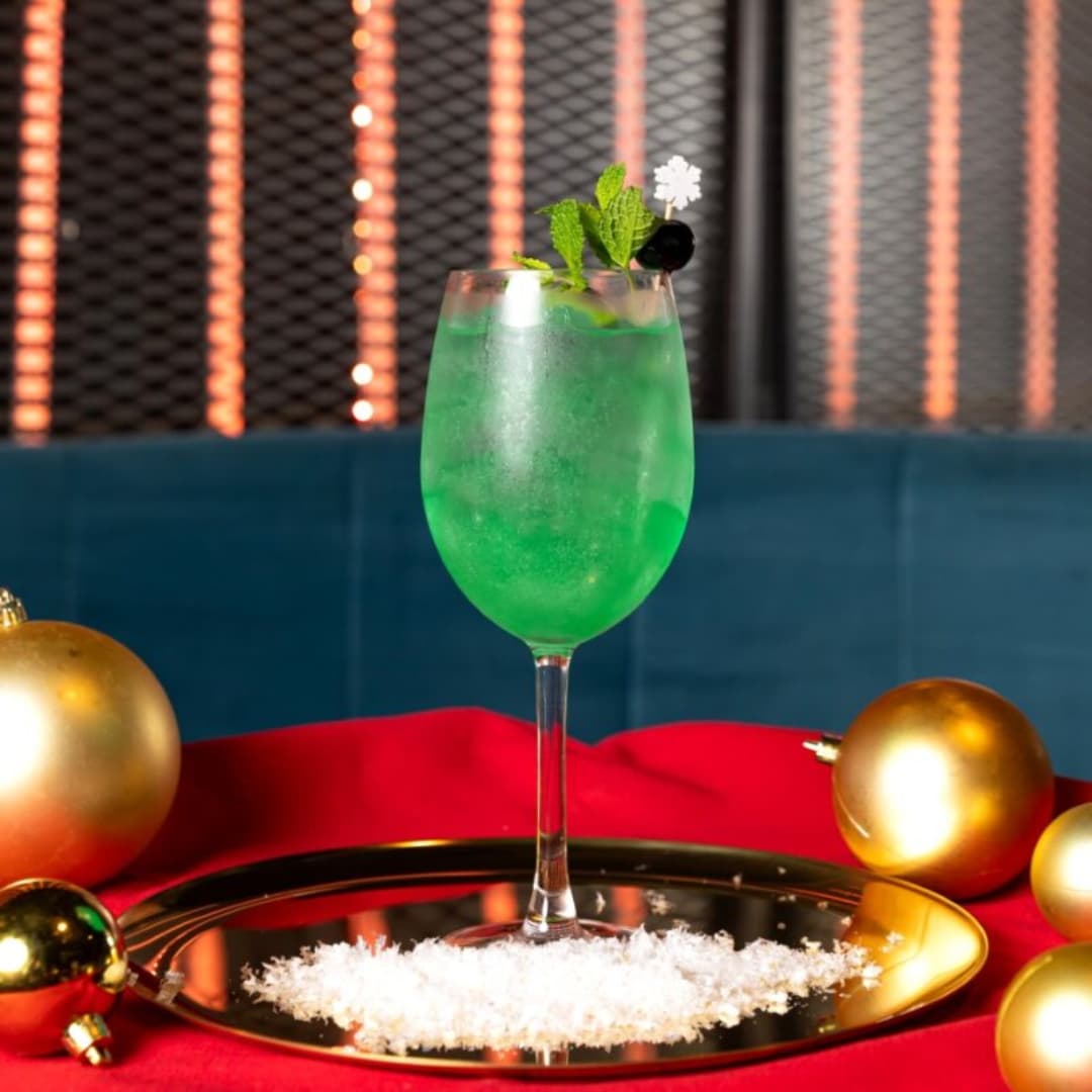 Green cocktail in wine glass